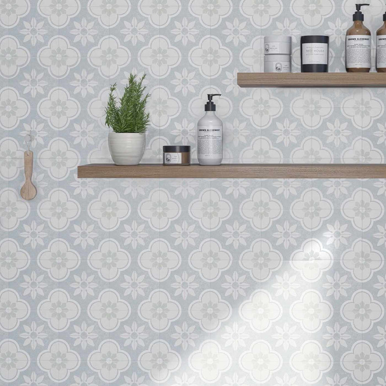 Bloom Mont patterned tiles set 15x15cm on a bathroom wall with wooden shelves featuring white vases and bathroom products.
