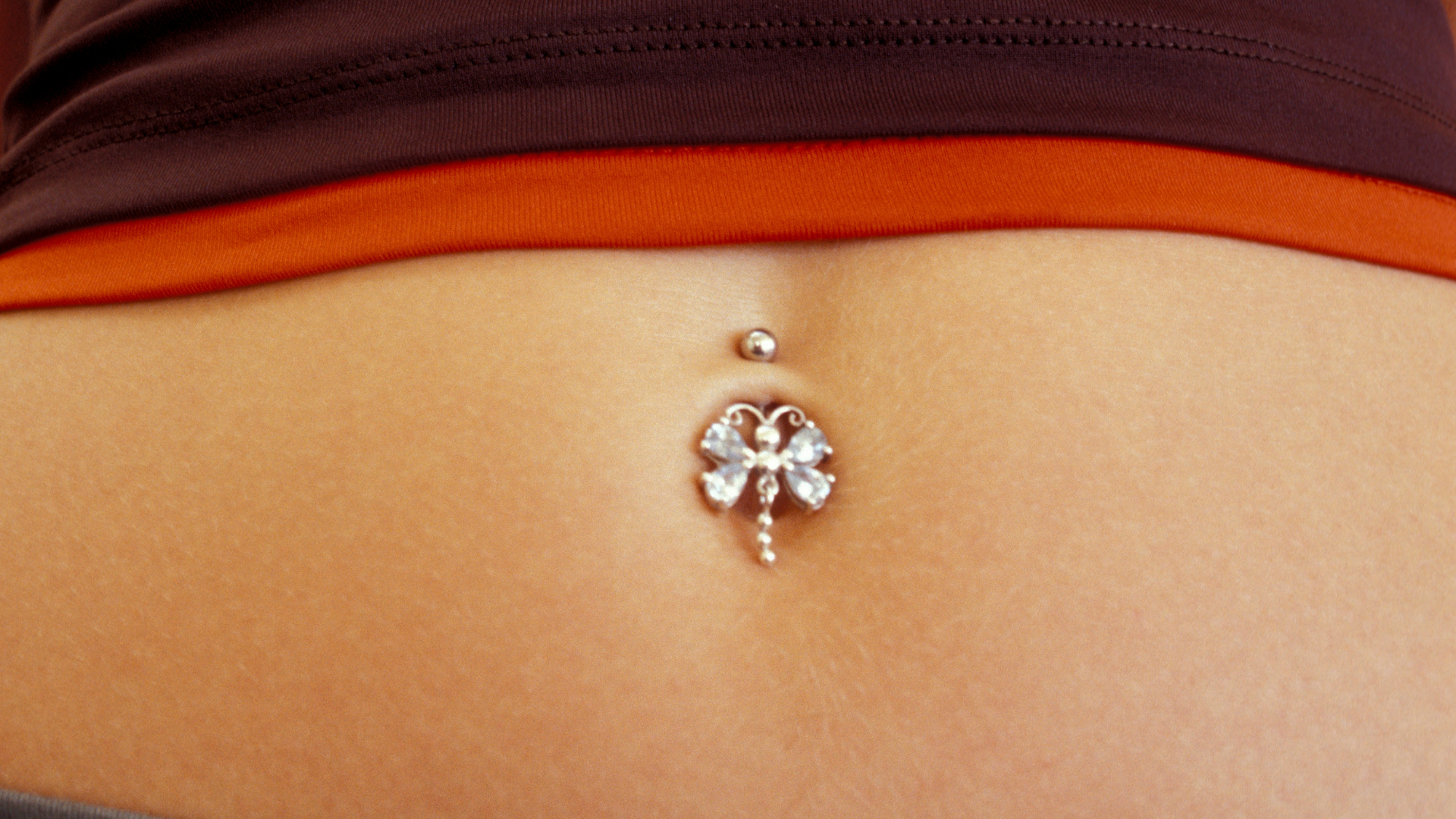 Navel piercing close up of female