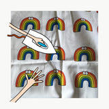 Fabric with rainbow pattern being ironed