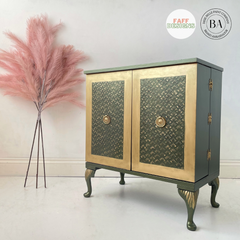 green cabinet with faux pink flowers