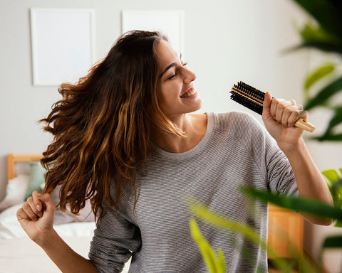 Happy Woman with Hair Brush