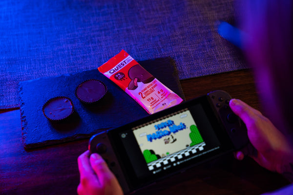 Playing Mario Bros while eating Quest PB cups