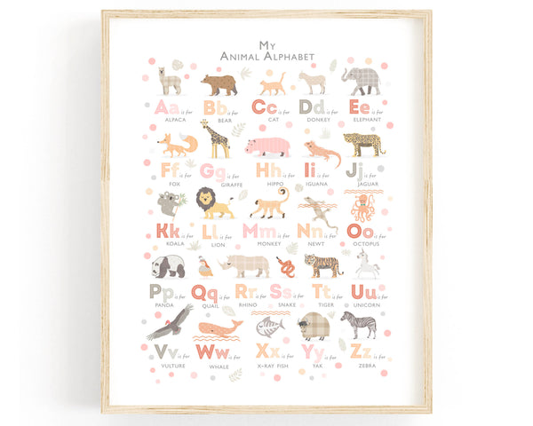 pink and peach animal alphabet in an oak frame on a white wall