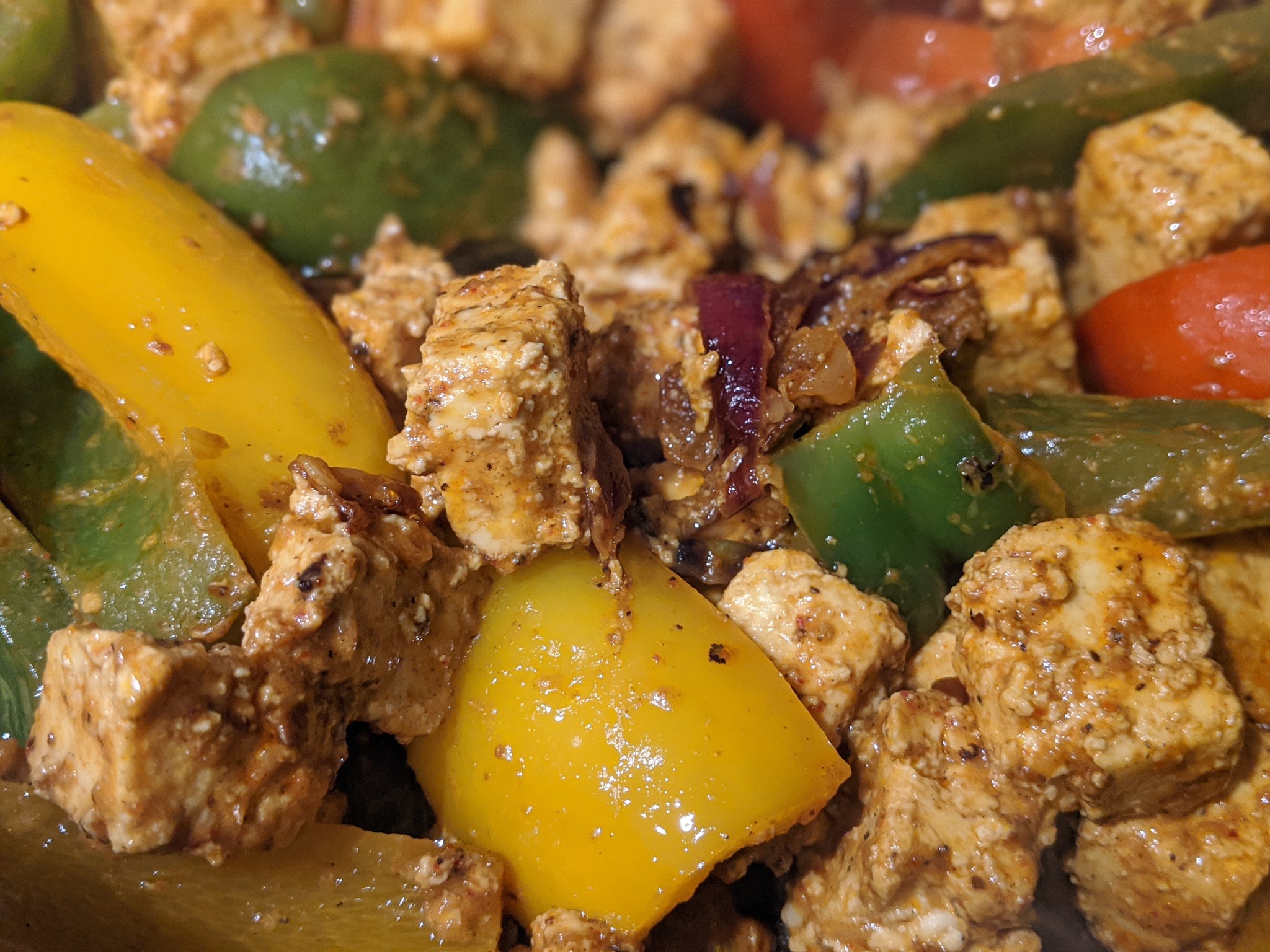 Paneer cubes being sauted with vegetables