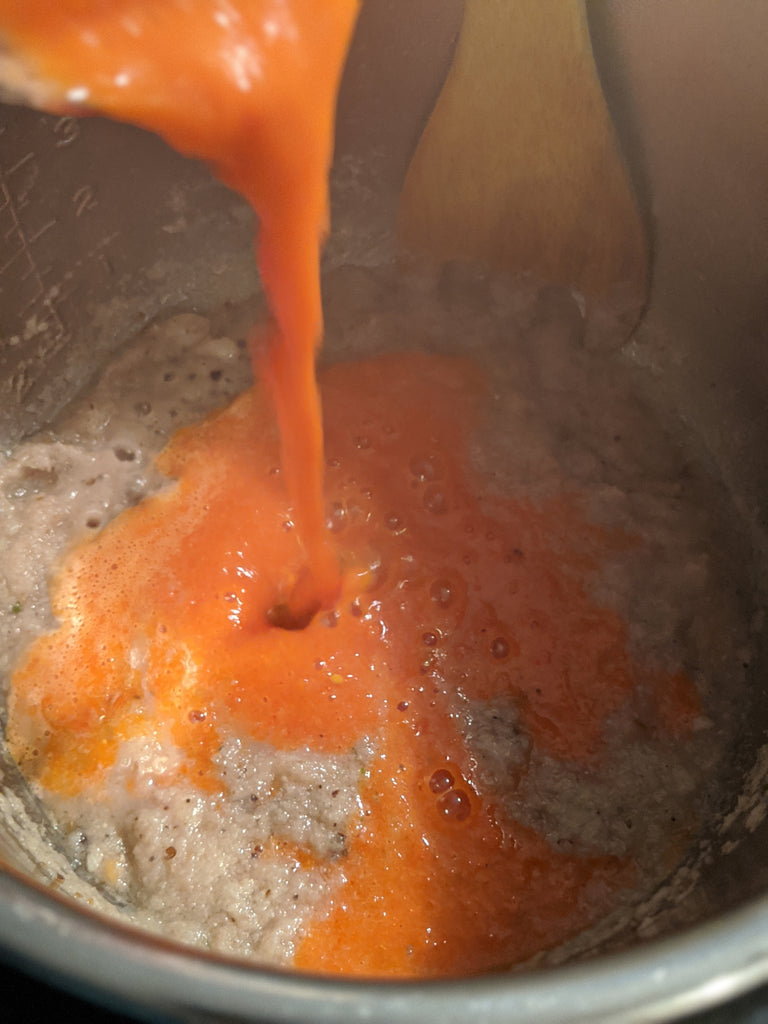 Adding the tomato/spice blend into the onion saute in the Instant Pot 