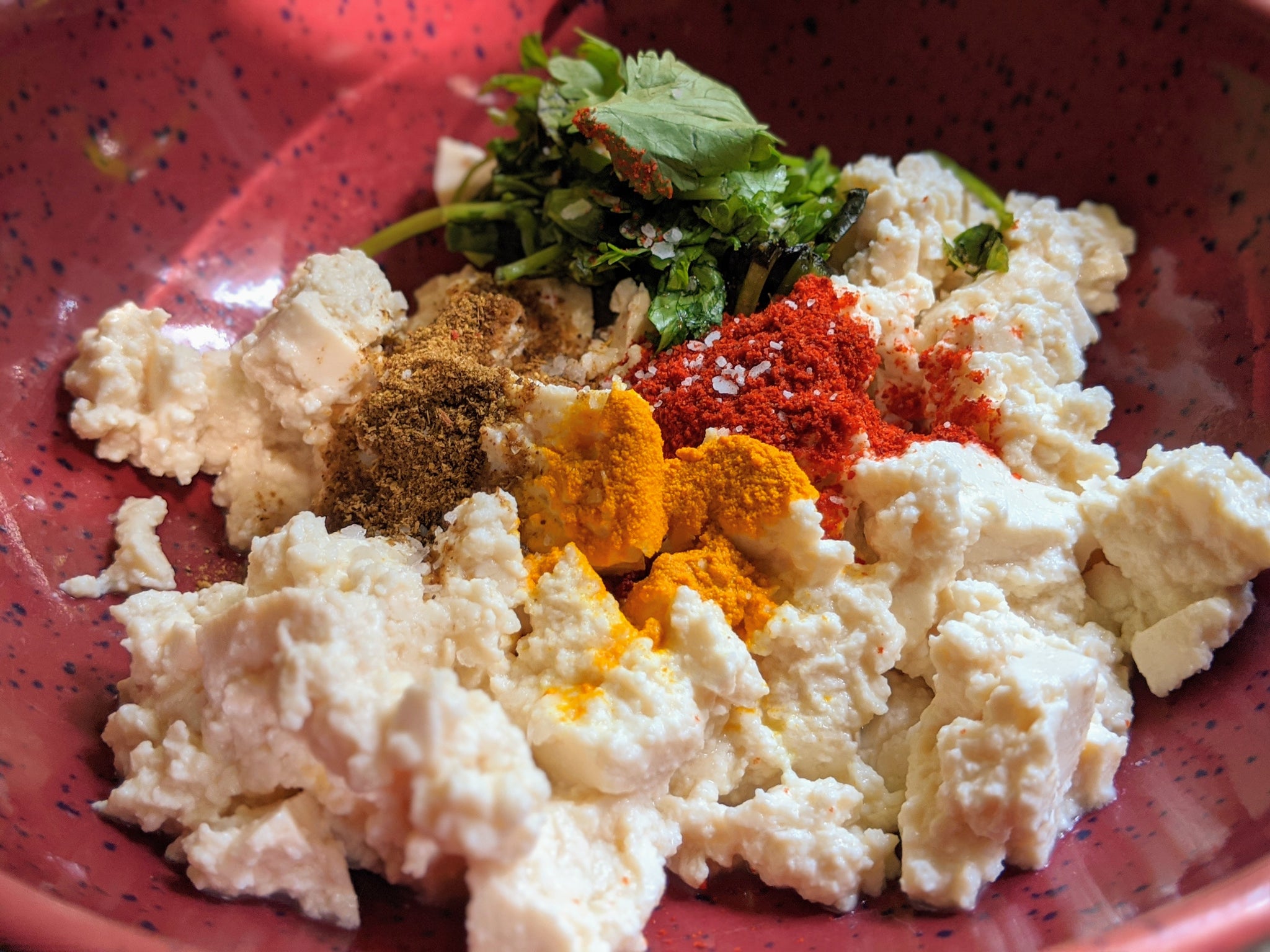 Pieces of tofu being marinated with SpiceFix Kashmiri Chili Powder, Turmeric Powder and Garam Masala Blend 