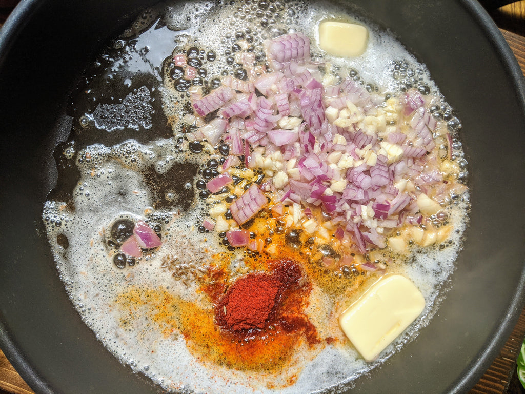 Suateing chopped onions with SpiceFix spices - Turmeric, Kashmiri Chili Powder, Cumin Seeds 