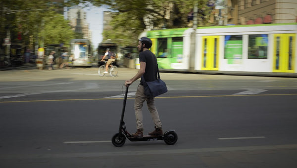 Man riding electric scooter in City
