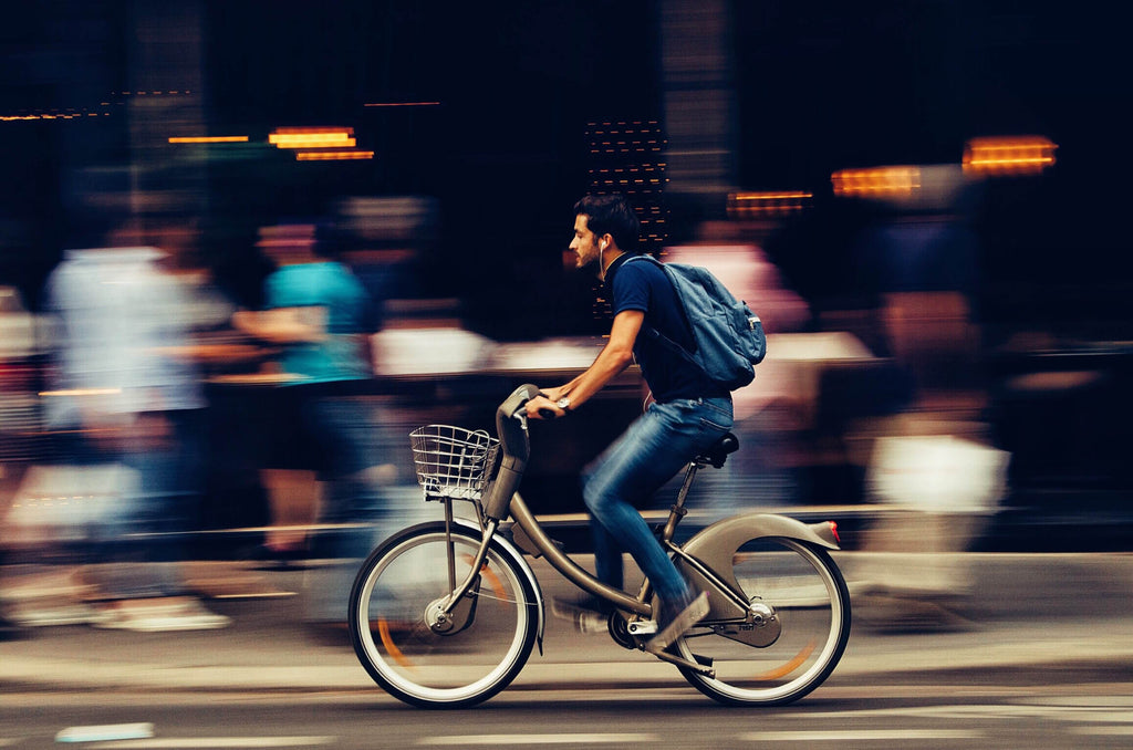 Man riding electric bike through a city