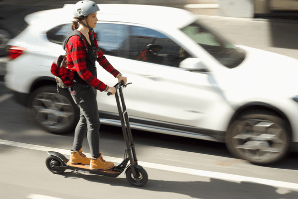 Woman riding electric scooter in city
