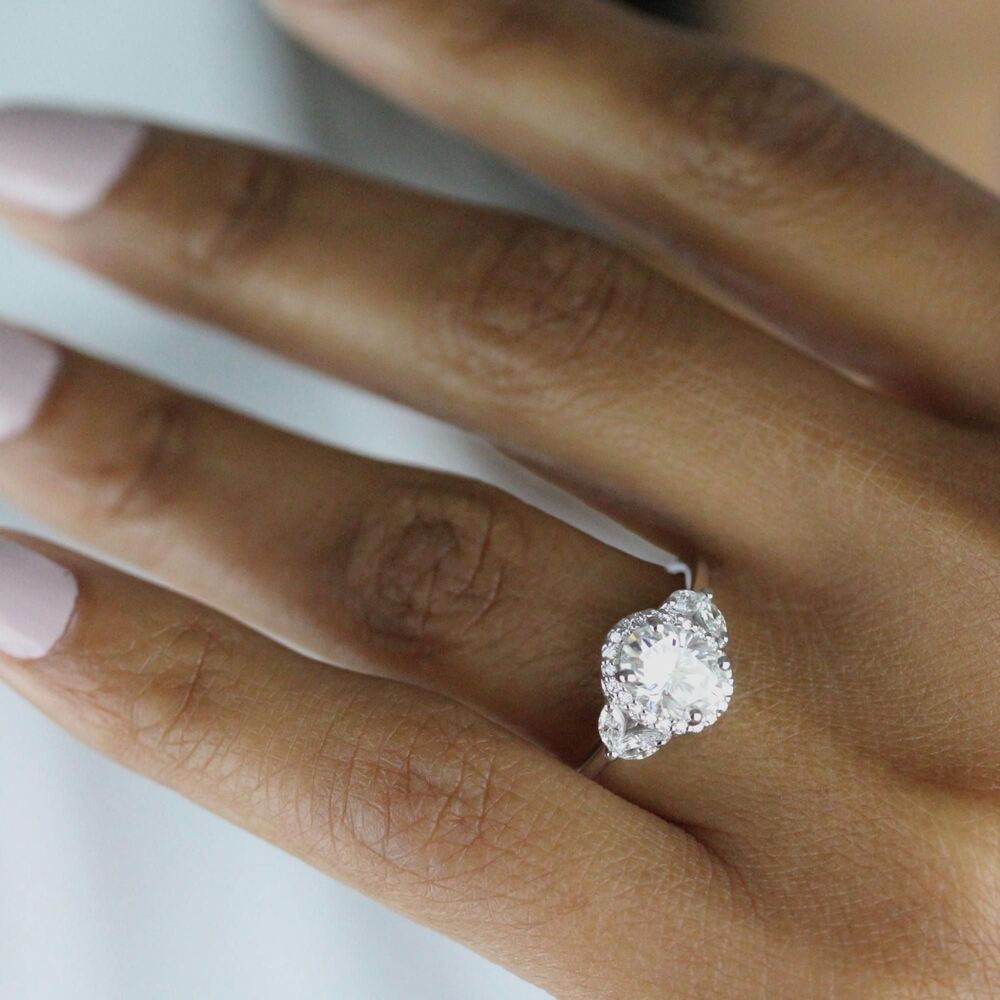 Hand wearing a customized halo engagement ring