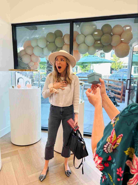 Surprised Woman Reacting to Outstretched Jewelry Box