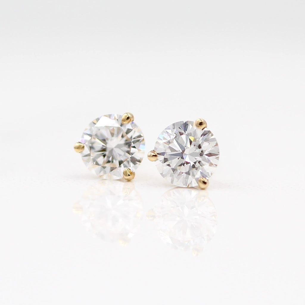 three-prong gold and diamond stud earrings