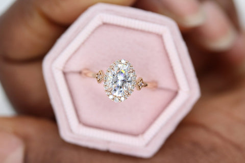 moissanite engagement ring with diamond accents displaying difference between moissanite and diamonds