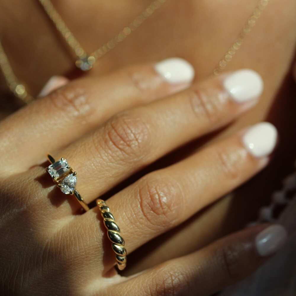 petite toi et moi diamond ring and petite croissant ring on a hand