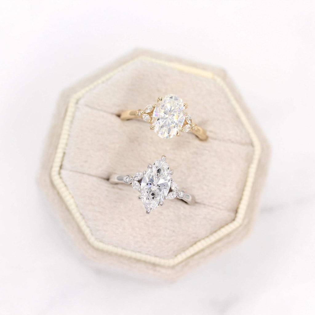 Yellow gold oval Sophia and white gold marquise Sophia engagement rings in a velvet box