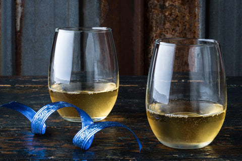 two stemless white wine glasses