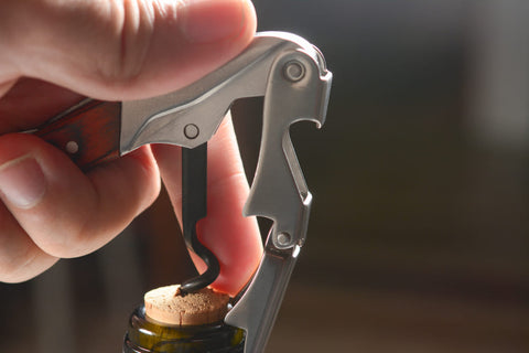 waiters corkscrew close up opening a wine bottle