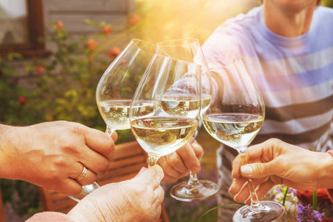 people toast with different types of white wine