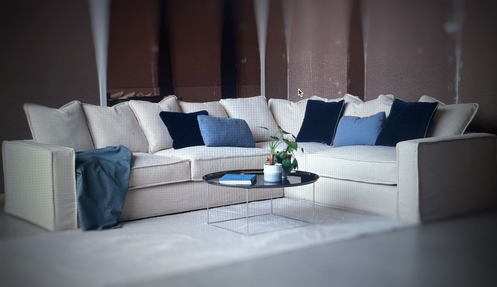 Cream-colored sofa displayed in a chic showroom – elegant and inviting furniture exhibit.