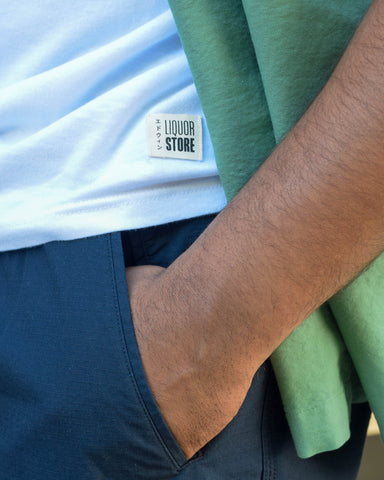 A close-up look at the logo of the Edwin x Liquor Store 10 year anniversary collaboration t-shirt.