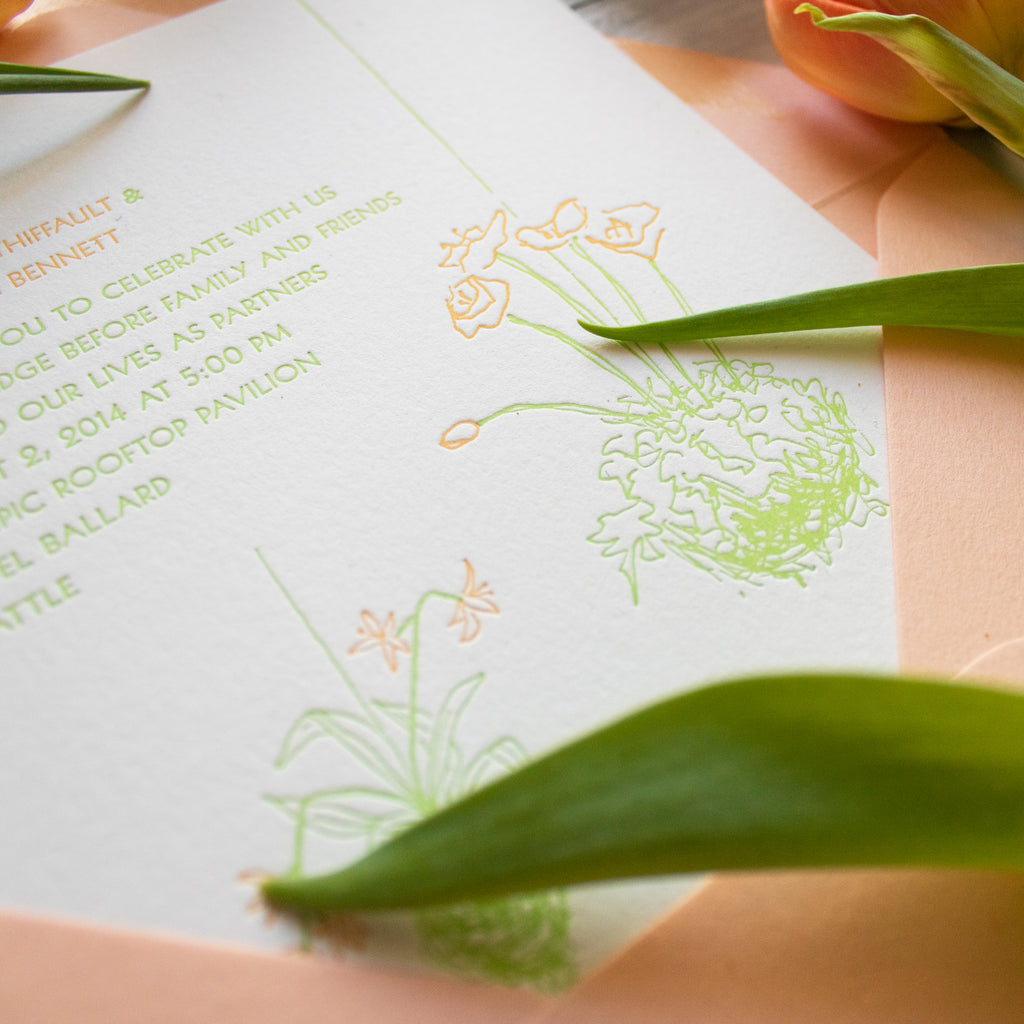 detail of letterpress kokedama floral design wedding invitations in spring green and peachy-orange inks