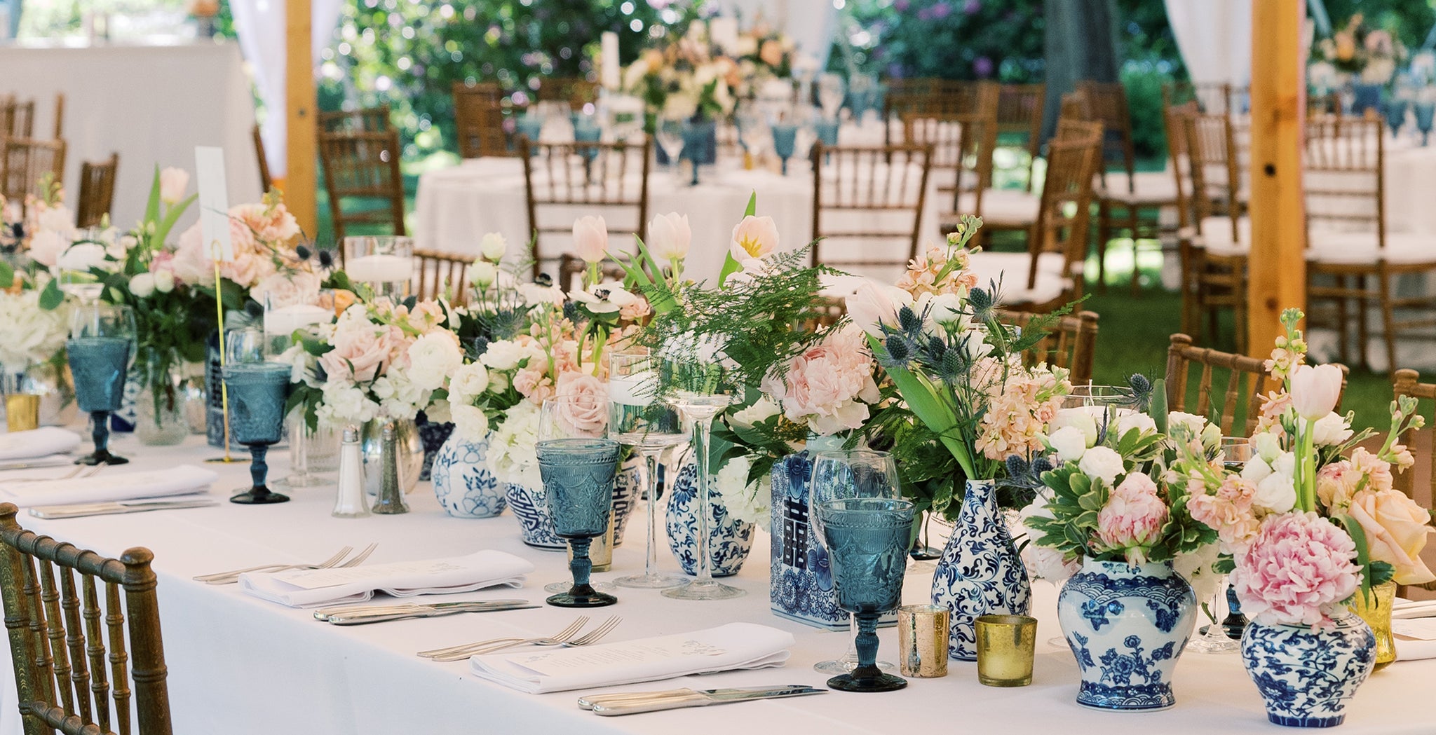 Suzie & Hunter's wedding tablescapes with clusters of blue and white ginger jars filled with pale pink peonies