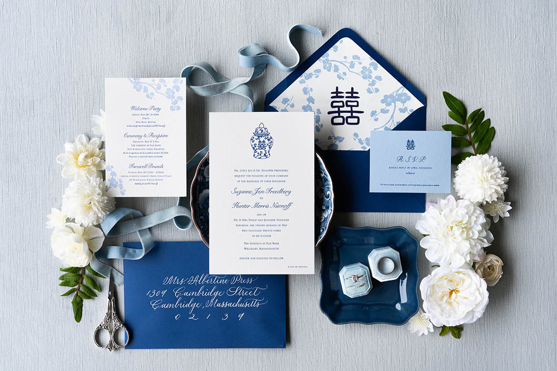 Suzie & Hunter's custom designed ginger jar, letterpress wedding invitation suite with plum blossoms, cherry blossoms, double happiness, hand calligraphy, edge painting, colored stock, and envelope liners in cobalt blue and white