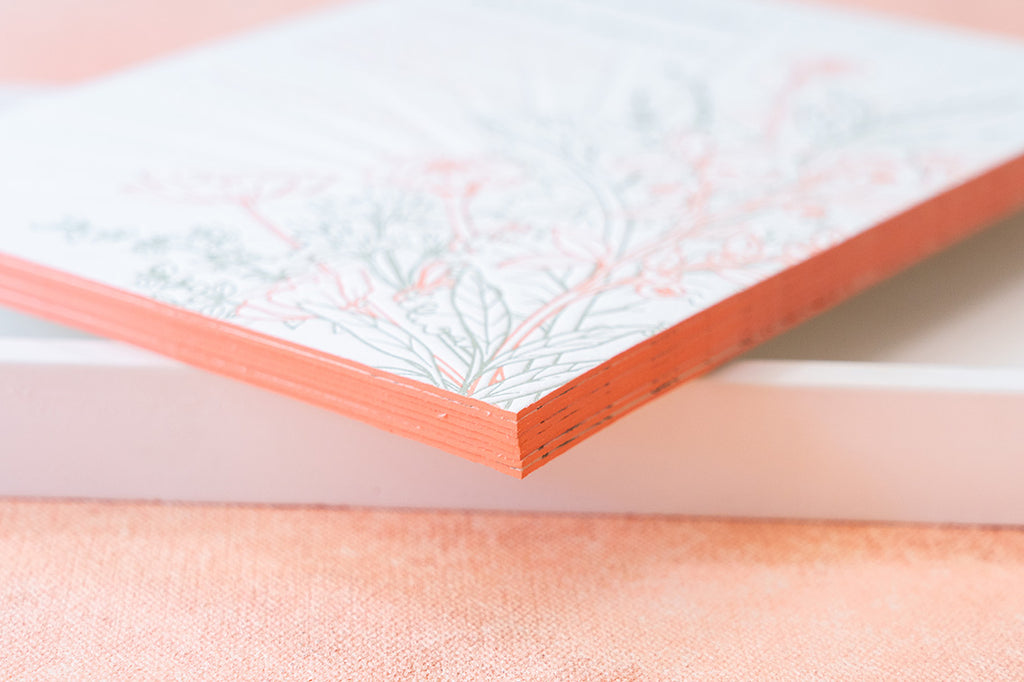 floral letterpress wedding invitation with orange edge painting