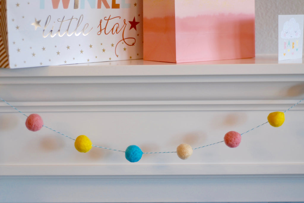 Felted Pom Pom Garland Hanging from Mantle