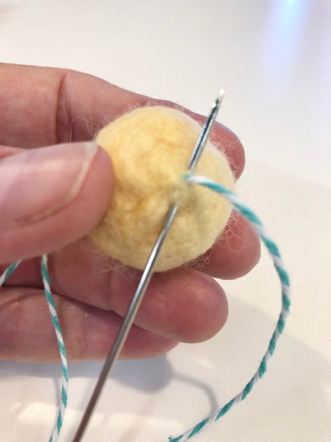 Stitch at Center of Threaded Pom Pom