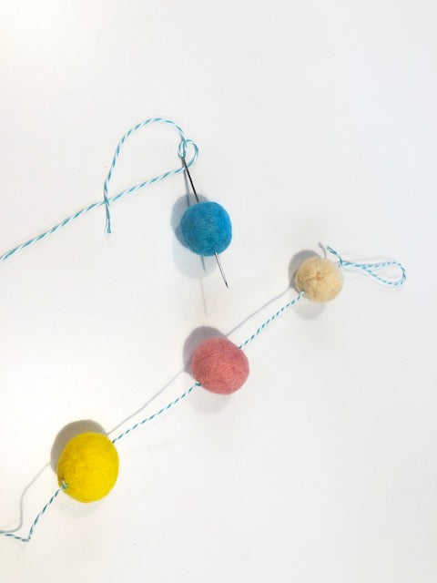 Four Colors of Felted Pom Poms Strung