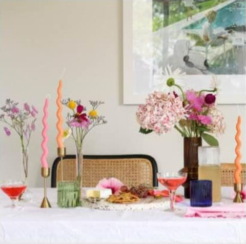 Dining table dressed with flowers and bendy candles