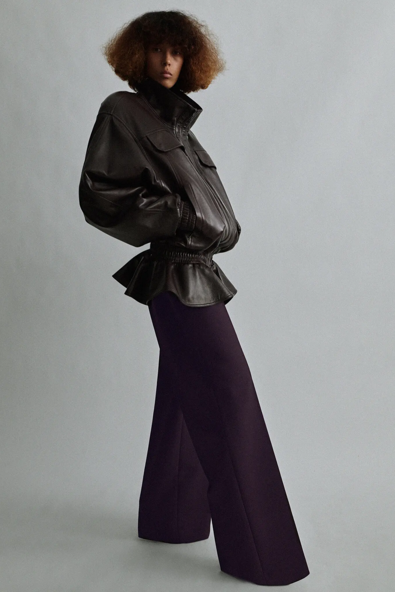The second Phoebe Philo drop continues to highlight leather outerwear, as in this dropped waist leather jacket, shown with oversize berry-colored wool trousers.