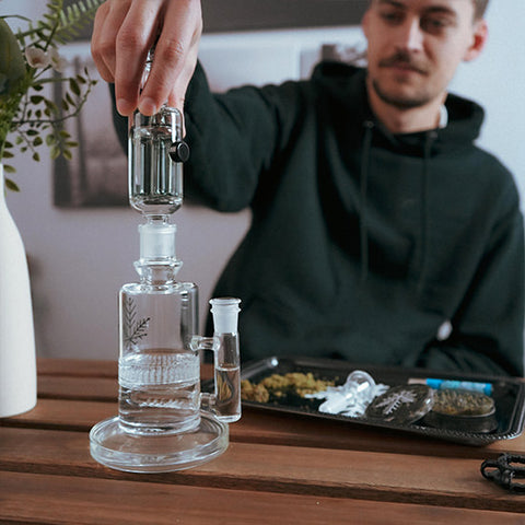 guy holding freeze mini bong