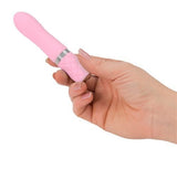 A hand holding pink pillow talk flirty bullet.