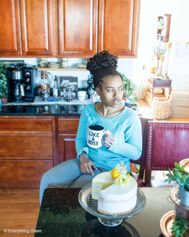 Lady with braided bun in hair holding like a boss coffee mug