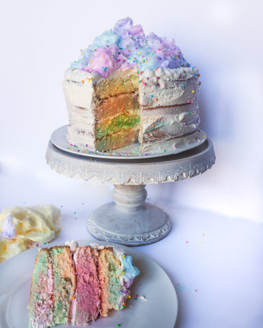 Cotton Candy Layered Cake with slice on a plate in front