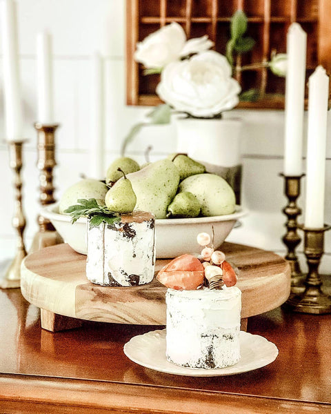 taper candles and faux cakes in vignette
