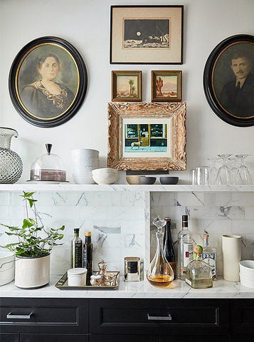 Kitchen wet bar with vintage art on wall