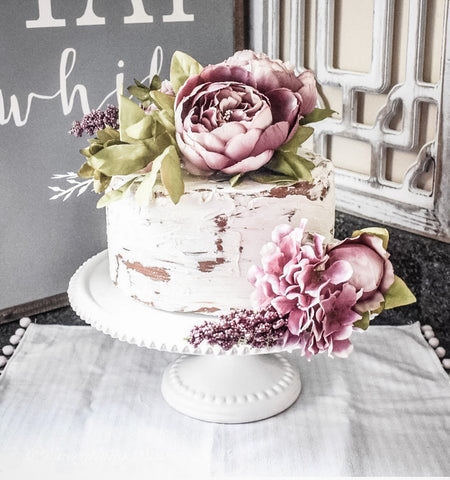 Faux Cake with spring pink flowers on cake stand