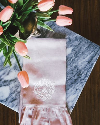 spring pink tulips on marble with pink linen ruffle towel