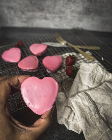 heart shaped cake in hand with linen tea towel