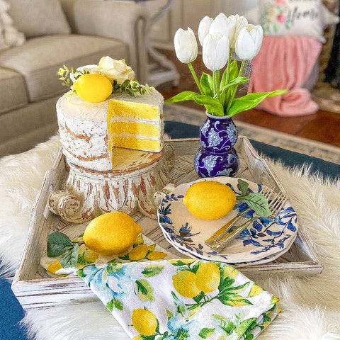 blue and yellow coffee table decor with lemon faux cake centerpiece