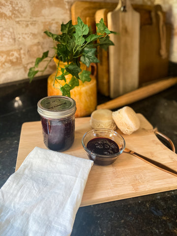 blueberry jam  on wooden board with a knife