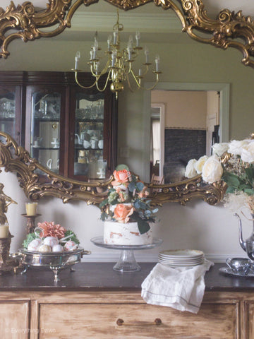 Faux Cake on Buffet Table With Flowers