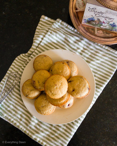 Muffins on a plate sitting on a towel