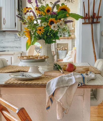 Faux apple pie on counter with a vase of sunflowers