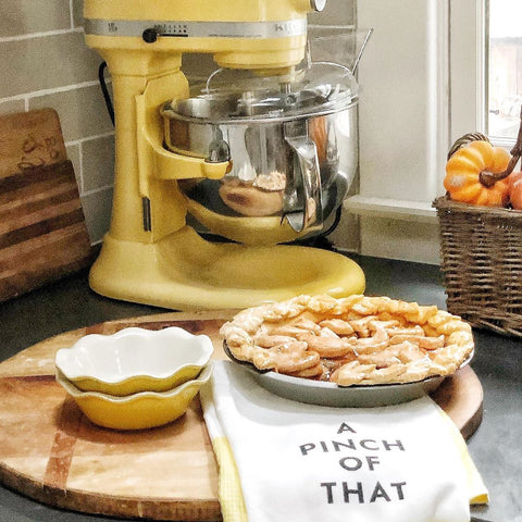 faux apple pie on counter beside mixer with hand towels