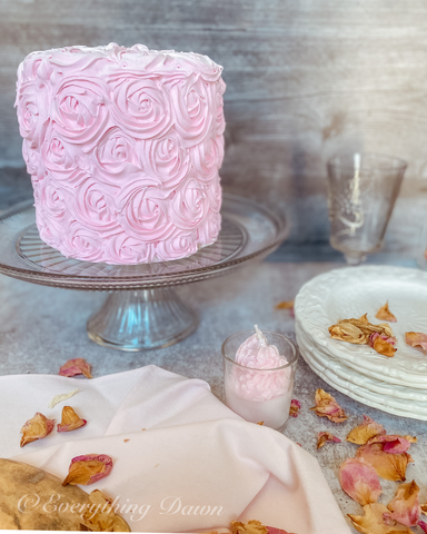 pink rosette cake with dried rose petals and pink candle